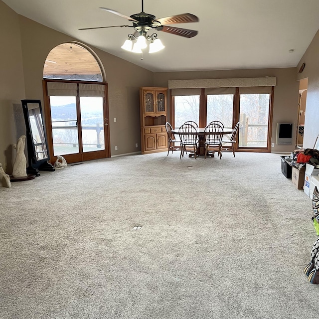 dining area featuring carpet floors, a wealth of natural light, ceiling fan, and vaulted ceiling