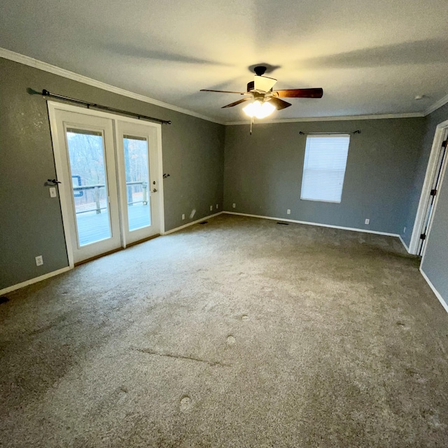 carpeted empty room with ornamental molding and ceiling fan