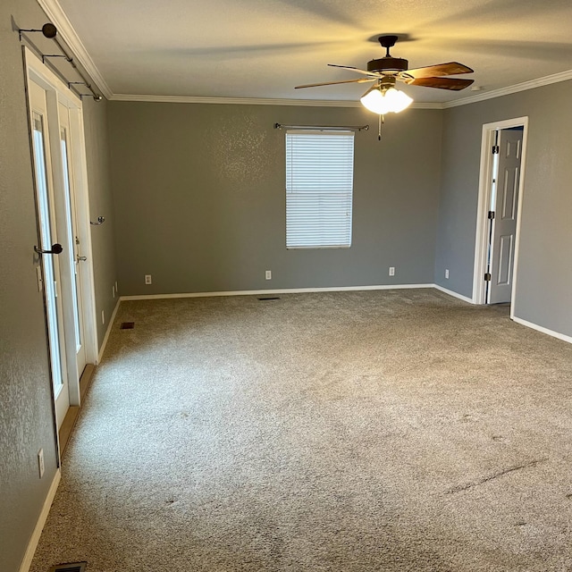 carpeted empty room with ornamental molding and ceiling fan