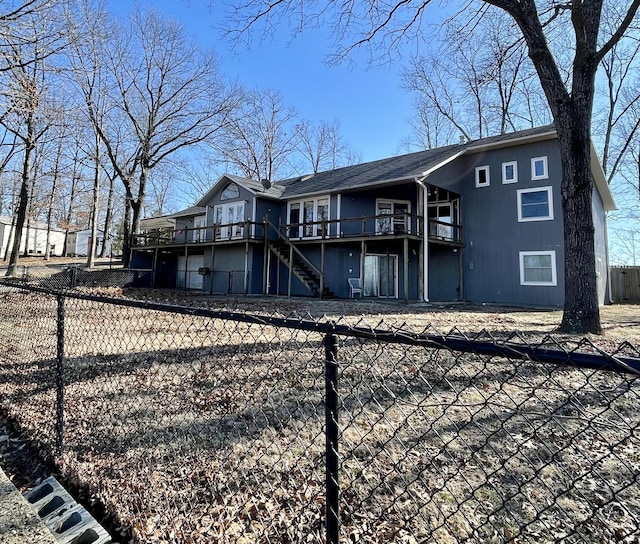 back of property featuring a wooden deck