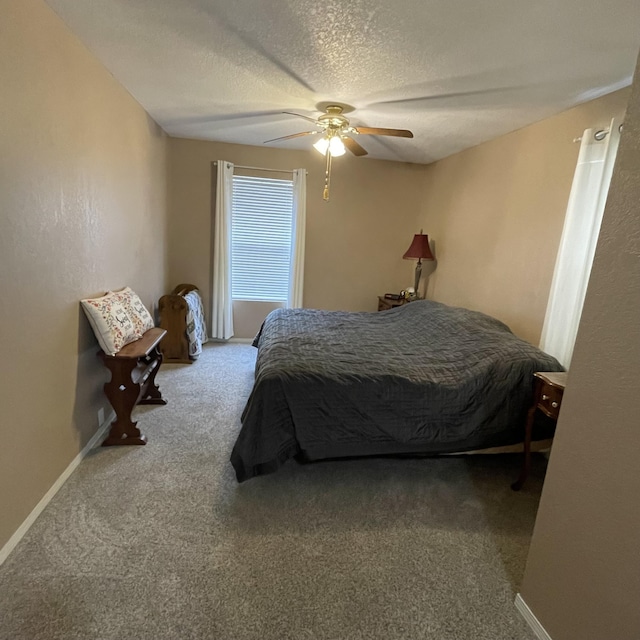 carpeted bedroom featuring a textured ceiling and ceiling fan