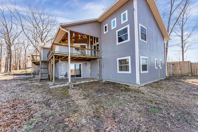 back of property with stairs, a patio area, fence, and a wooden deck