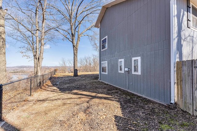 view of side of property featuring fence