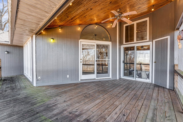 wooden deck featuring ceiling fan