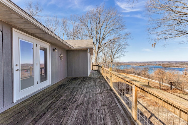 deck featuring a water view and fence