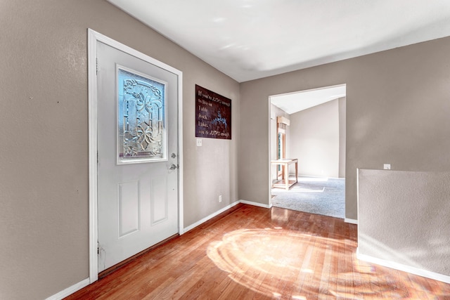 entrance foyer featuring baseboards and wood finished floors