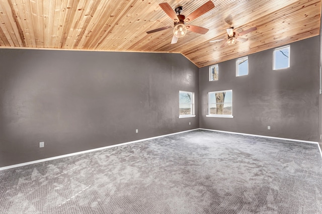 empty room with carpet, wood ceiling, baseboards, and high vaulted ceiling