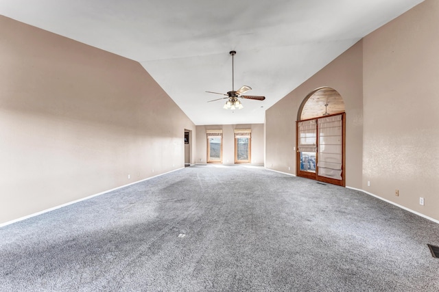 unfurnished living room featuring carpet floors, ceiling fan, high vaulted ceiling, and baseboards