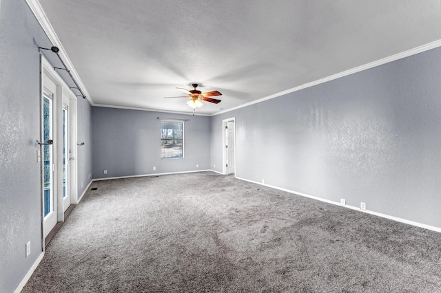 empty room featuring a textured wall, carpet floors, a ceiling fan, baseboards, and ornamental molding