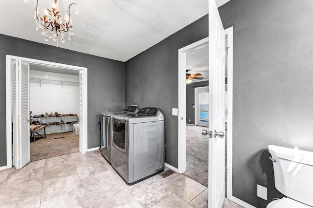 clothes washing area with ceiling fan, laundry area, carpet flooring, baseboards, and washer and clothes dryer