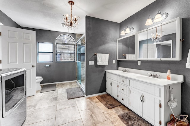 full bath featuring a chandelier, a stall shower, washer / clothes dryer, and a sink