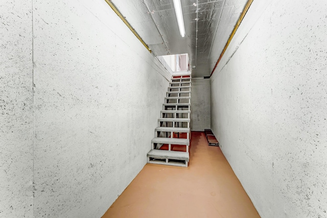 stairs featuring concrete floors