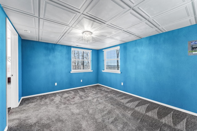 unfurnished room with an ornate ceiling, carpet flooring, and baseboards