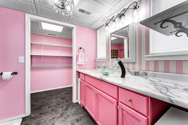 bathroom with visible vents, vanity, and baseboards