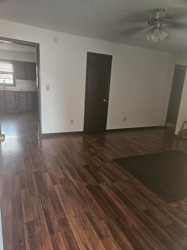 spare room featuring dark hardwood / wood-style floors and ceiling fan