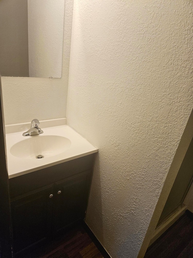 bathroom featuring hardwood / wood-style floors and vanity