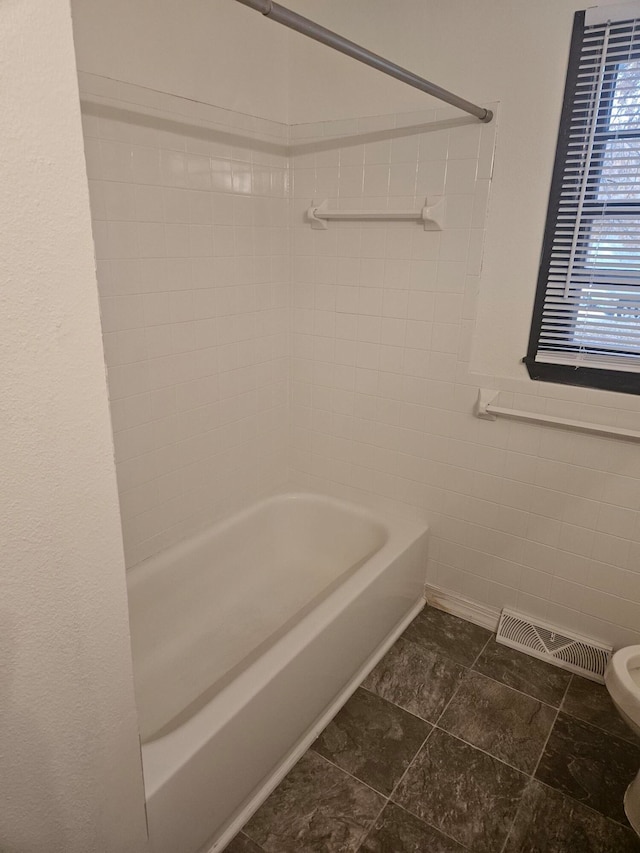 bathroom featuring toilet and shower / bathing tub combination