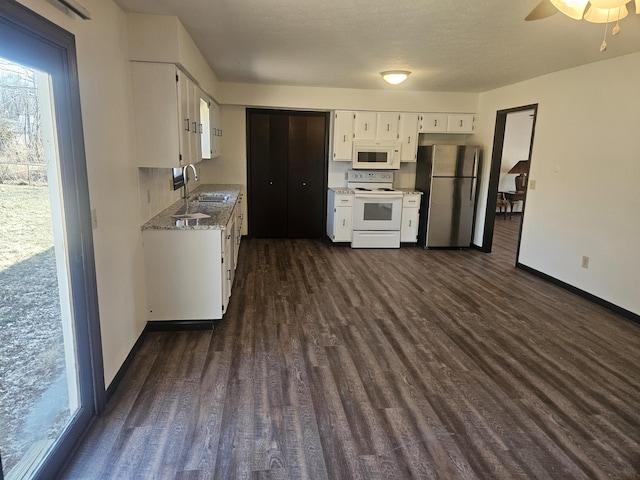 kitchen featuring white cabinets, dark wood-type flooring, sink, and white appliances