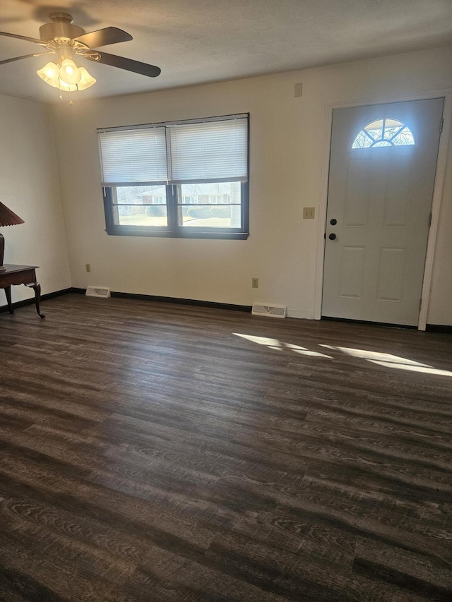 foyer entrance with dark wood-type flooring and ceiling fan