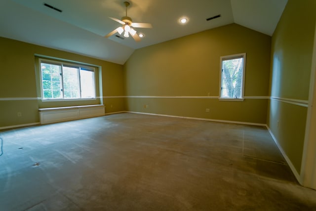 empty room featuring ceiling fan, lofted ceiling, and carpet flooring