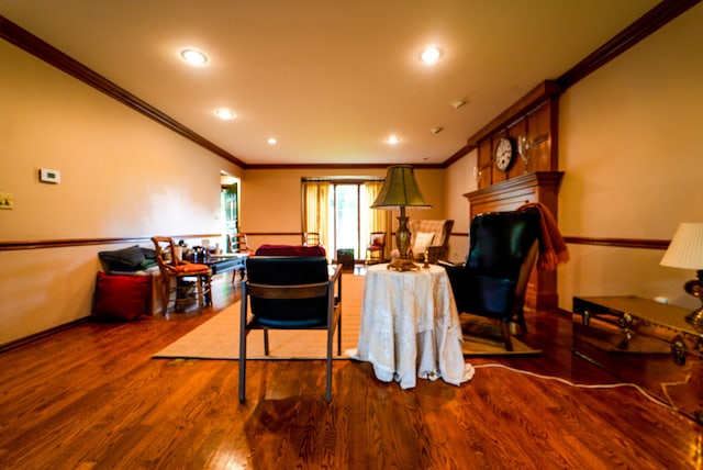 living room featuring a large fireplace, crown molding, and dark hardwood / wood-style flooring