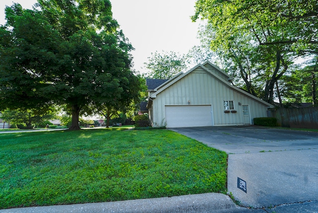 view of property exterior featuring a yard and a garage