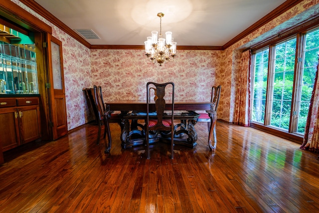 dining area featuring crown molding, a chandelier, and dark hardwood / wood-style floors