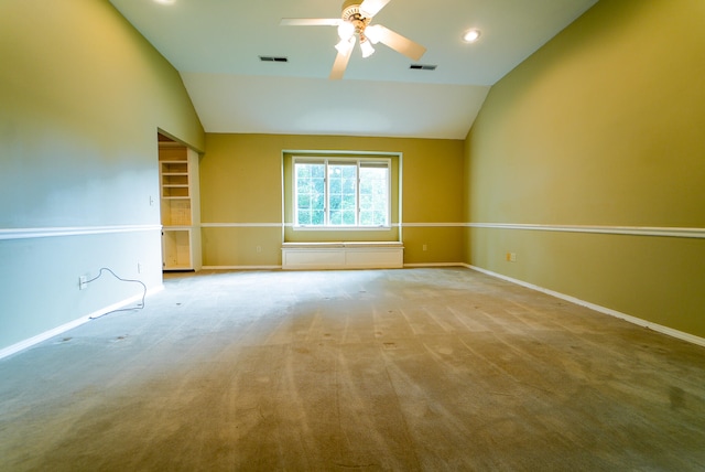 carpeted spare room featuring lofted ceiling and ceiling fan