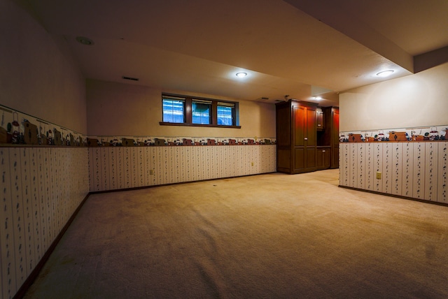 basement featuring light colored carpet