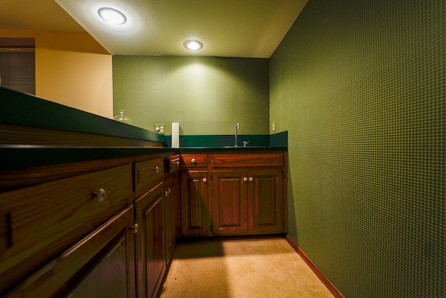 bar featuring light colored carpet and sink