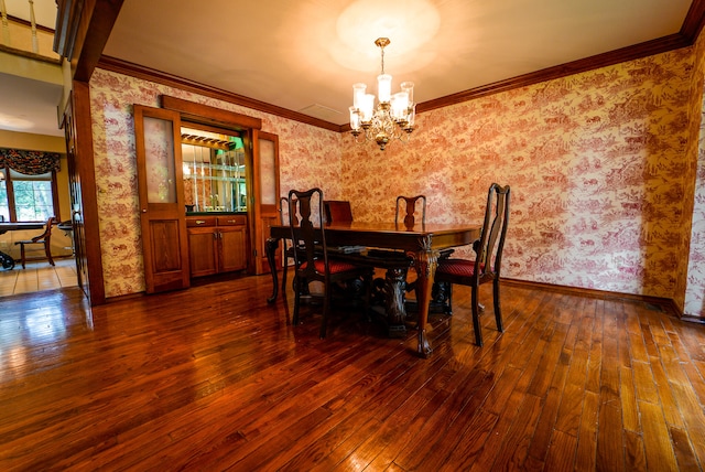 dining room with crown molding, a chandelier, and dark hardwood / wood-style flooring