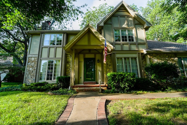 tudor-style house with a front lawn