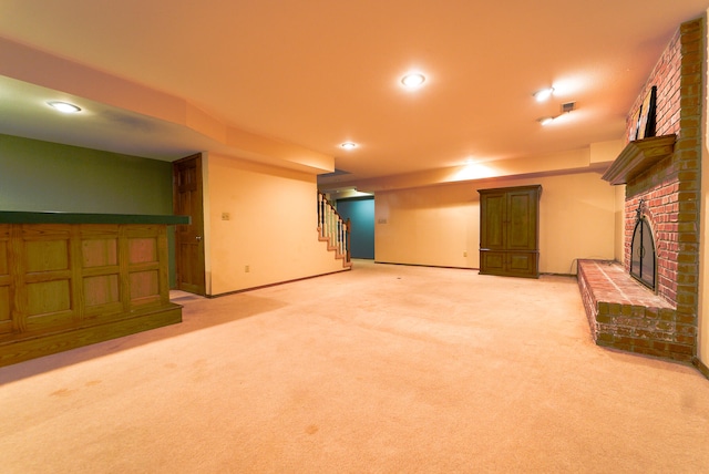 basement featuring light carpet and a fireplace