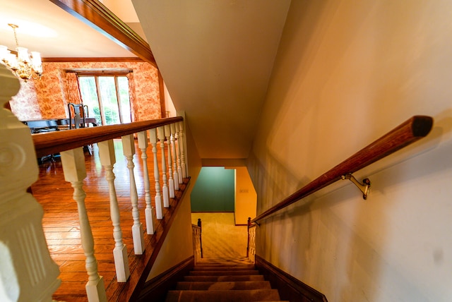 stairway with a notable chandelier