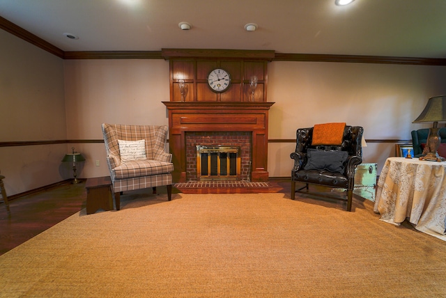 living area with a brick fireplace, dark wood-type flooring, and ornamental molding