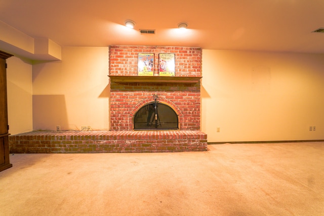 unfurnished living room featuring a fireplace and carpet flooring