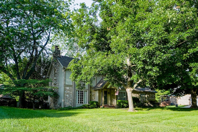 obstructed view of property featuring a front lawn