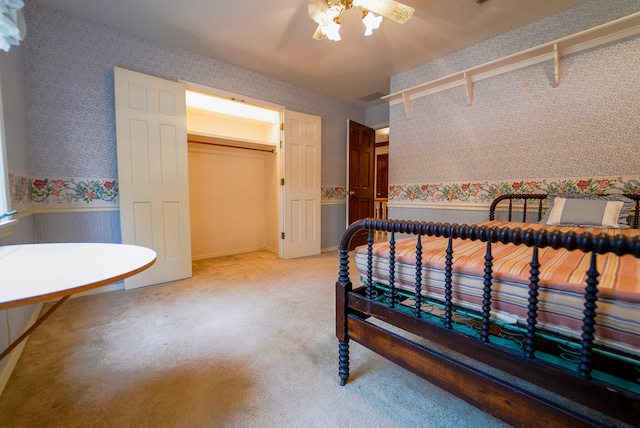 carpeted bedroom featuring a closet and ceiling fan