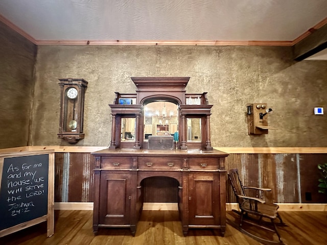 bar featuring wood-type flooring and ornamental molding