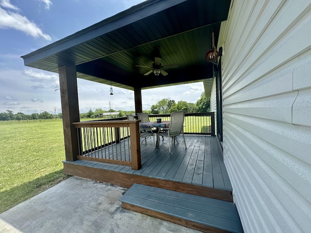 wooden terrace with a yard and ceiling fan