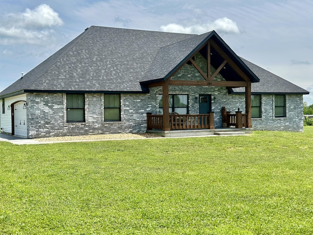 back of house featuring a yard, a porch, and a garage