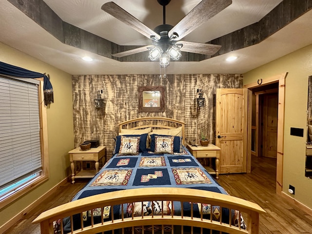 bedroom with hardwood / wood-style flooring and ceiling fan