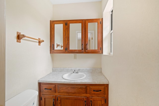 bathroom with vanity and toilet