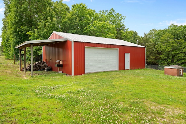 view of outdoor structure featuring a garage and a lawn