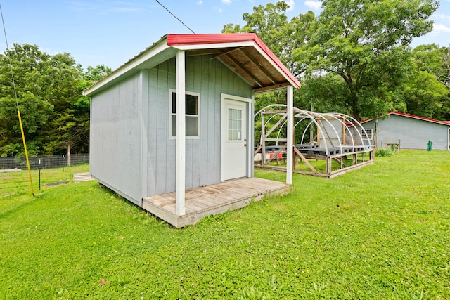 view of outbuilding featuring a yard