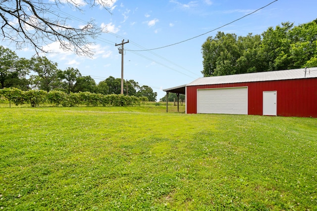 view of yard with a garage and an outdoor structure