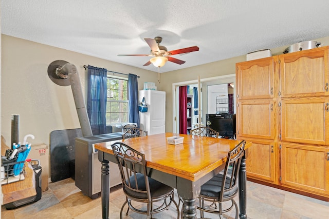 dining space with ceiling fan and a textured ceiling