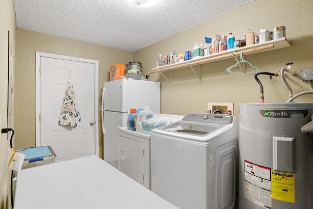 laundry room with separate washer and dryer, water heater, and a textured ceiling