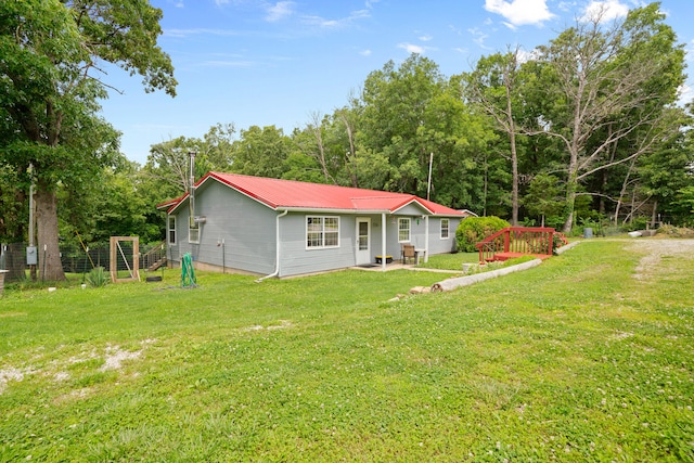 view of front of house featuring a front yard and a patio