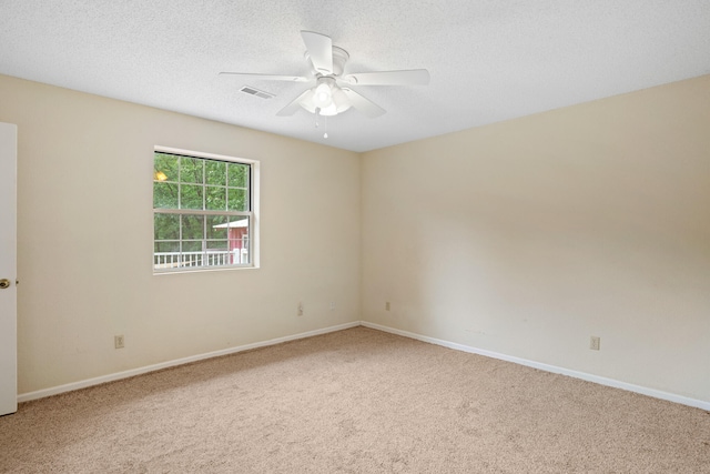 carpeted empty room with a textured ceiling and ceiling fan